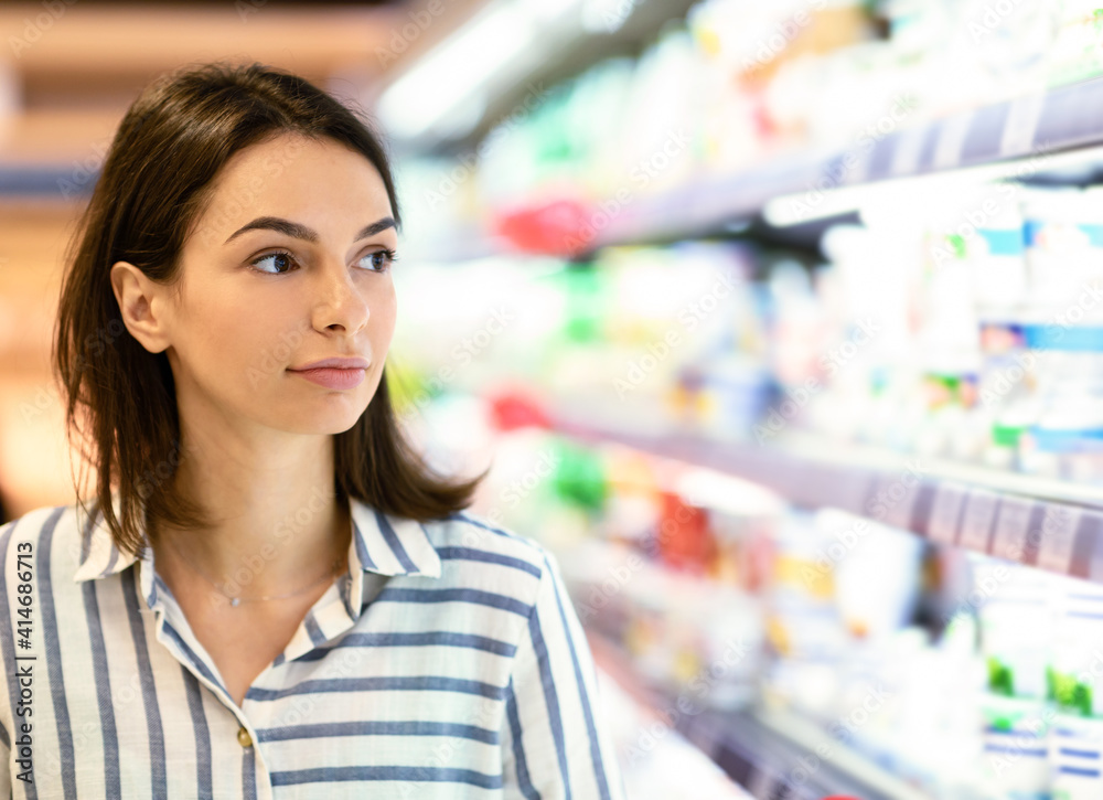 Closeup portrait of young woman shopping in supermarket