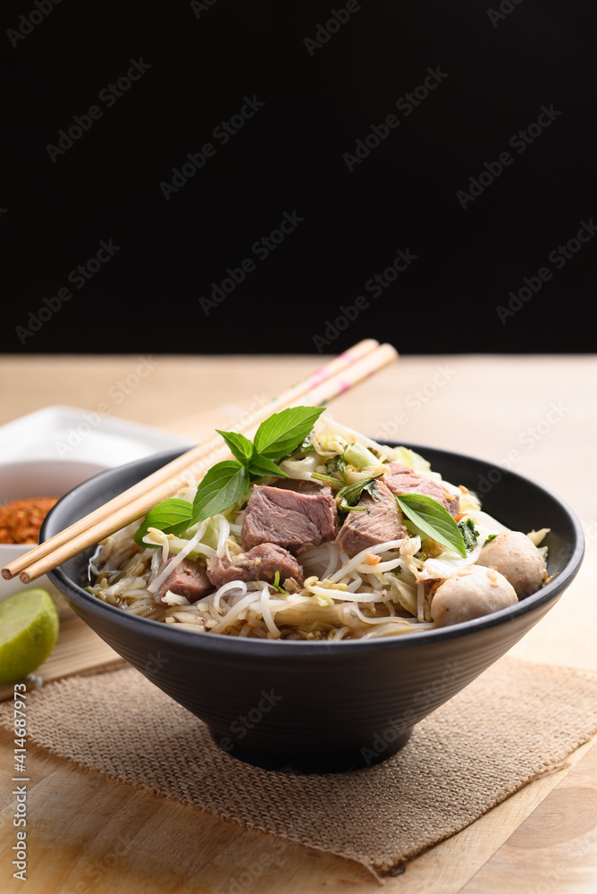 Rice noodle soup with pork, pork ball and vegetables in a bowl, Thai noodles soup Rice noodle soup with pork, pork ball and vegetables in a bowl, Thai noodles soup