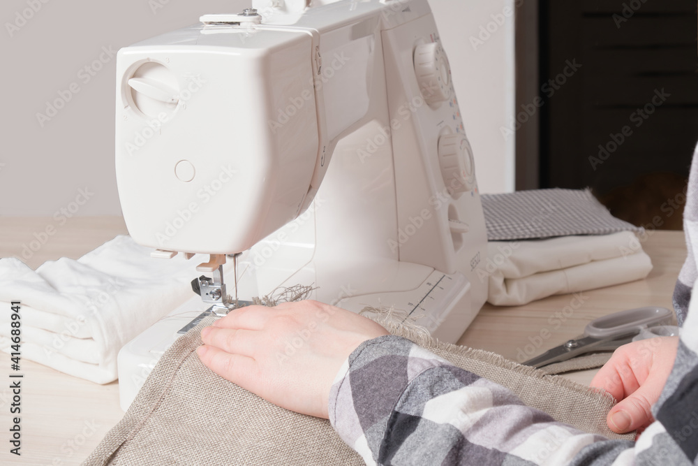 woman working with sewing machine, white sewing machine on table