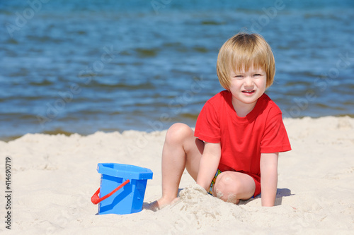 Cute girl playing on a sandy beach