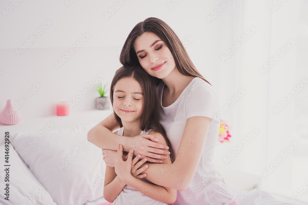 Photo of charming shiny two sisters sleepwear sitting bed having rest closed eyes inside indoors home room Photo of charming shiny two sisters sleepwear sitting bed having rest closed eyes inside indoors home room