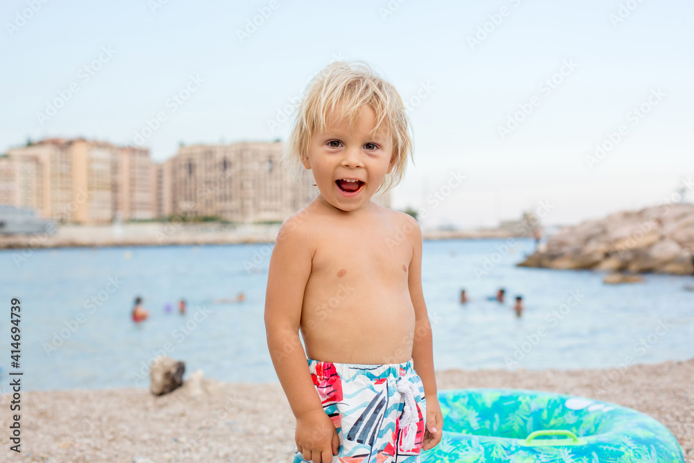 Cute blond toddler child, boy, drinking vitamin pills Cute blond toddler child, boy, drinking vitamin pills