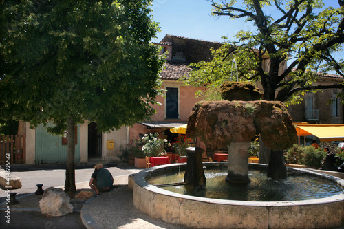 Vaugines in the Vaucluse, Provence-Alpes-Côte d'Azur, France: the ancient mossy village fountain in the main square.  photo