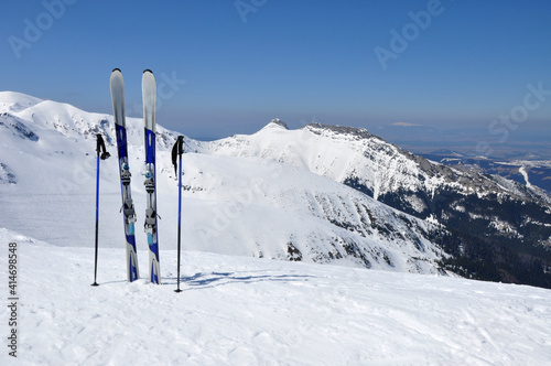 A pair of skis, ski poles and Giewont in Tatra mountains in Poland.