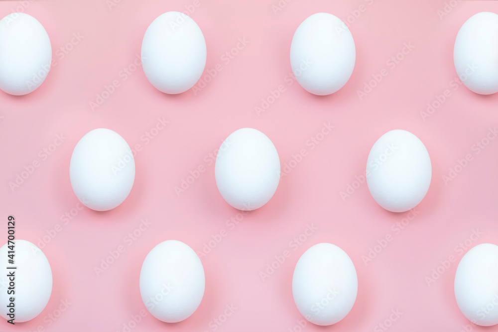 white eggs on a light pink background white eggs on a light pink background