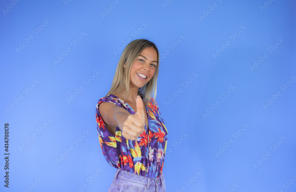 Woman in summer clothes raising her thumb smiling Woman in summer clothes raising her thumb smiling