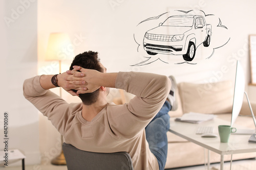 Obraz na plátne Man dreaming about new car in office during break