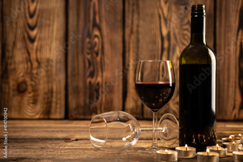 Red wine glasses and bottle red wine on old wooden background. 