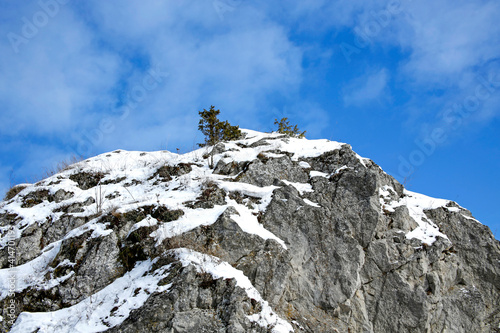 limestone rocks covered with snow against the blue sky