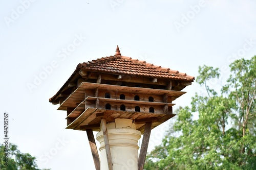 red wooden dove nest on a pole with white background photo