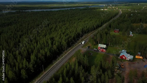 Aerial drone view of a camper driving in a arctic village, sunny, summer day photo