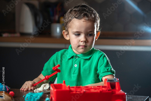 Boy's is playing with clay.