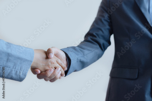 business man and business woman shaking hands for success deal a partnership together. friendship hand shake greeting.