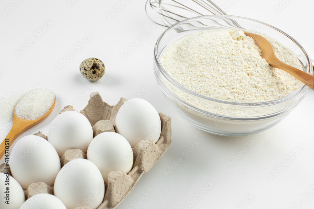 Eggs and quail eggs and sugar, coconut shavings in wooden spoons Eggs and quail eggs and sugar, coconut shavings in wooden spoons