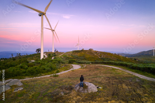 Photographer in Casa do Penedo drone aerial view in Fafe with wind turbine, Portugal photo