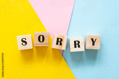 Sorry wordmade from wooden blocks over colorful backgrounds