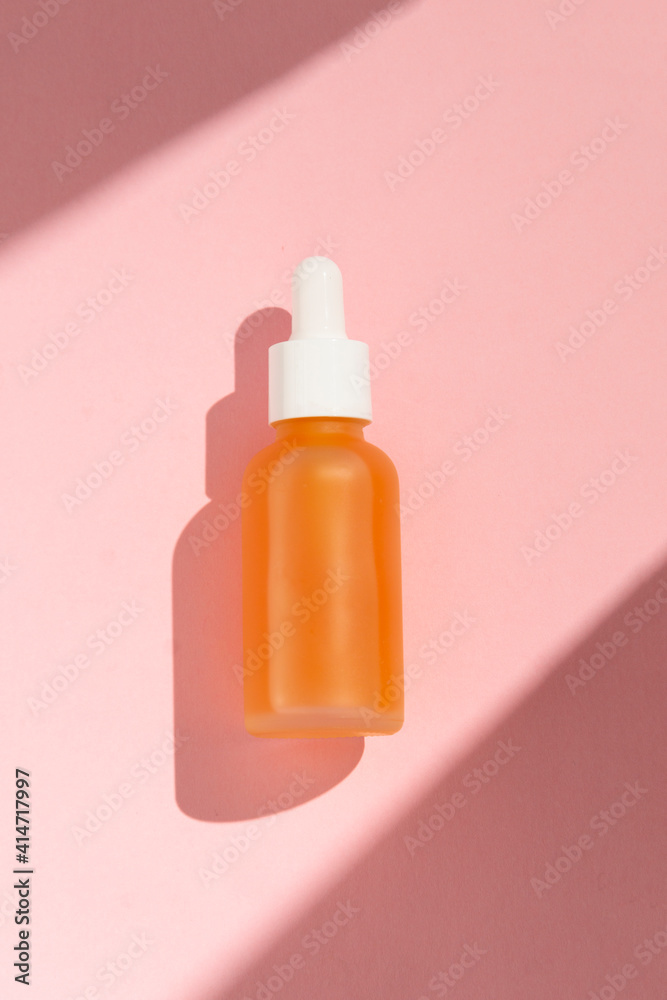 Essence oil, vitamin c serum, beauty cosmetics, aroma therapy. Natural shades, pink background Essence oil, vitamin c serum, beauty cosmetics, aroma therapy. Natural shades, pink background