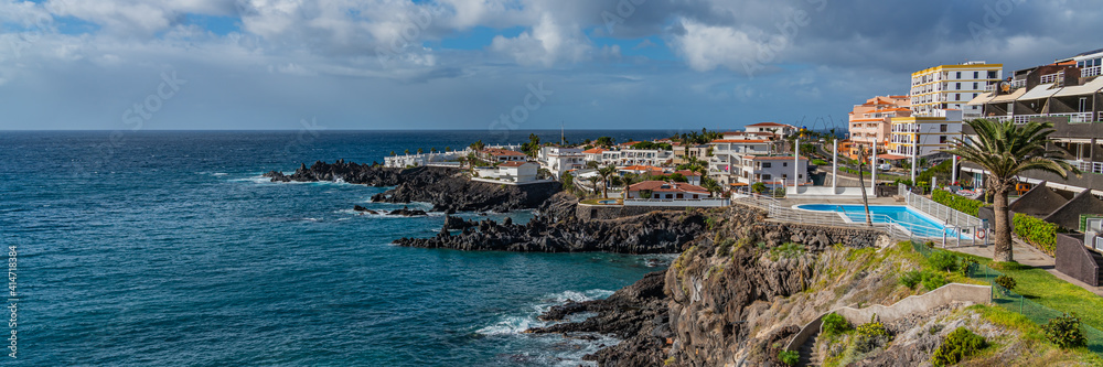 Tropical island of Tenerife. Panorama of the Coastline with buildings with a pool