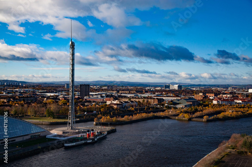 Glasgow / Scotland - Nov 13, 2013: Fall in the city. Clyde river embankment. Glasgow Science Centre and Tower. Steam ship. (Paddle-wheel steamer). Panorama view. Blue sky with clouds.