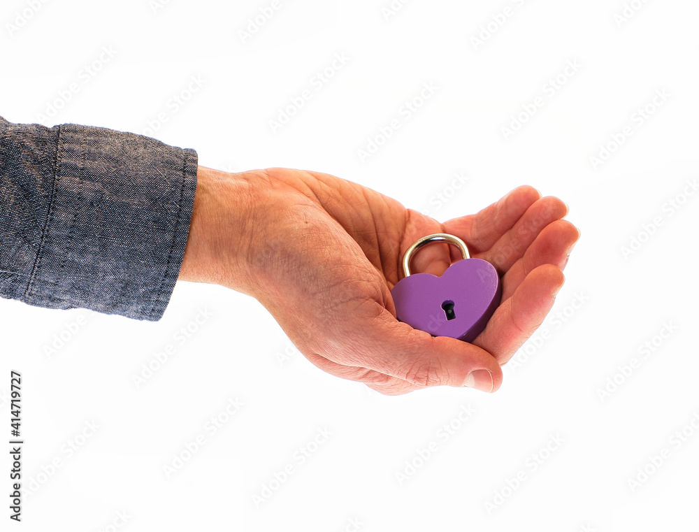 Fototapeta premium hands holding a heart padlock