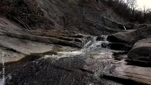 Wallpaper Mural Close flight drone flight over water in near of a waterfall at daytime Torontodigital.ca