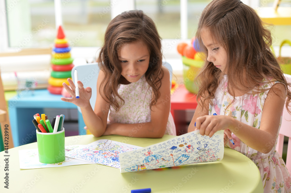 Two cute little girls drawing with pencils Two cute little girls drawing with pencils