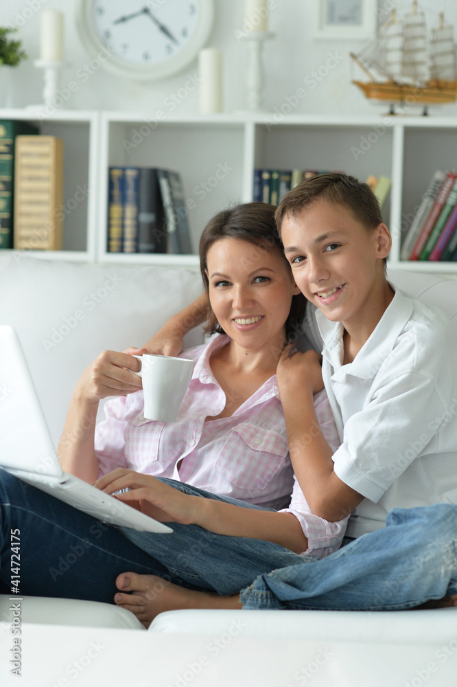 Mother and son using modern laptop at home Mother and son using modern laptop at home