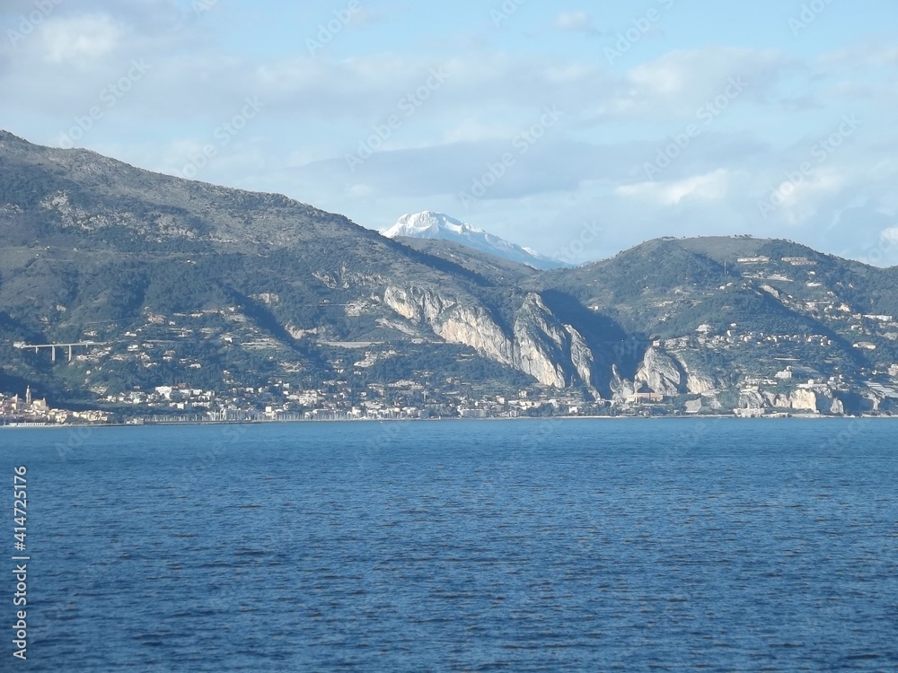 view towards the cote d’azur with the snow capped mediterranean alps in the background
