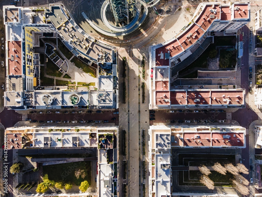 Aerial view of a pedestrian walkway in a fancy residential district near the old Gulp oil refinery tower in Lisbon, Portugal.