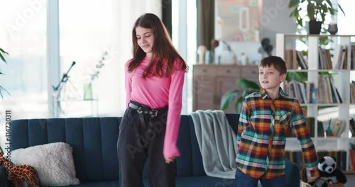 Wallpaper Mural Couple of adorable brother and sister kids dancing in living room for online broadcast video vlog having fun together. Young bloggers. Vlogging lifestyle. Torontodigital.ca