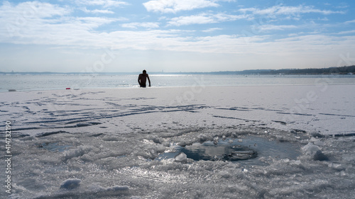 Athlete comes out of the water after ice swimming in a lake