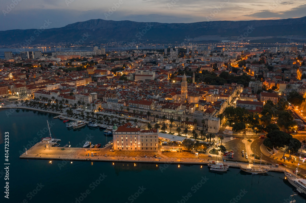 Aerial drone shot of Diocletian Palace at dusk in Split old towni with lights before sunrise in Croatia