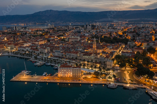 Aerial drone shot of Diocletian Palace at dusk in Split old towni with lights before sunrise in Croatia