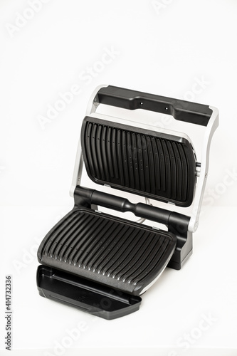 electric grill with open lid. appliance for cooking in everyday life. Made of stainless steel, special non-stick coating. healthy food. food without oil and fat. 