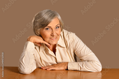 portrait of happy senior woman at table