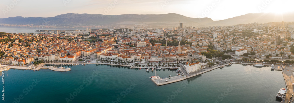 Aeril panoramic drone shot of Diocletian Palace in rising sun light morning in Split old town Croatia