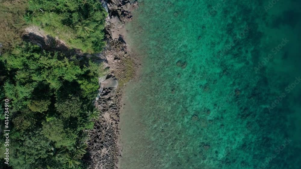 Top down aerial view of the tropical sea with wave crashing against an empty stone rocks cliff from above in blue ocean Open Sea. beautiful sea surface aerial view drone shot,High angle view Top down aerial view of the tropical sea with wave crashing against an empty stone rocks cliff from above in blue ocean Open Sea. beautiful sea surface aerial view drone shot,High angle view