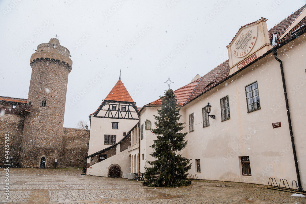 Renaissance courtyard, Baroque medieval castle with stone gothic tower, historical building on the Otava, snow in winter day, Strakonice, Southern Bohemian region, Czech Republic