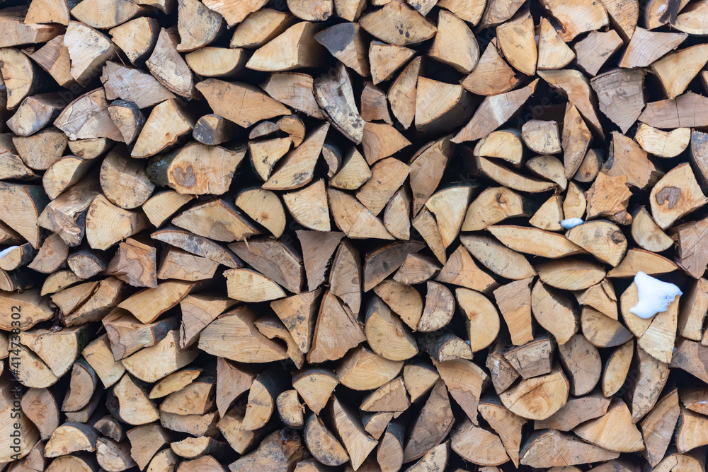 Stacked stack of firewood. Large woodpile with chopped wood. Stacked stack of firewood from the end. Stacked stack of firewood. Large woodpile with chopped wood. Stacked stack of firewood from the end.