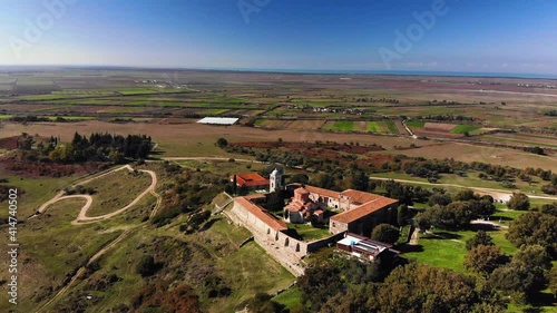 View from drone of ancient ruins, monastery and beautiful, green fields photo