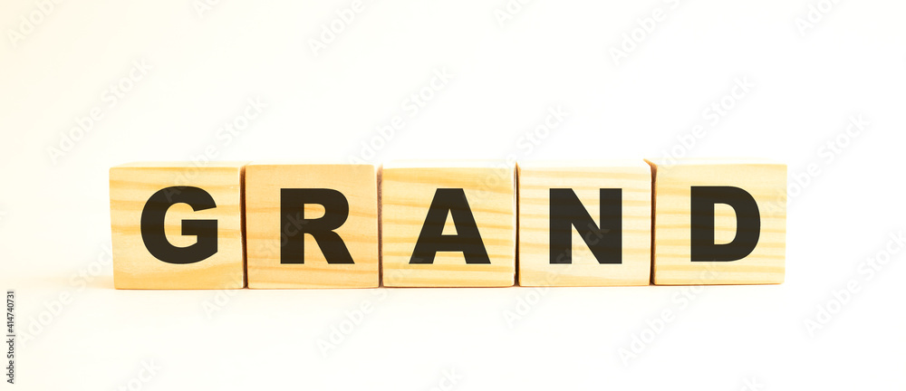 The word GRAND. Wooden cubes with letters isolated on white background. The word GRAND. Wooden cubes with letters isolated on white background.