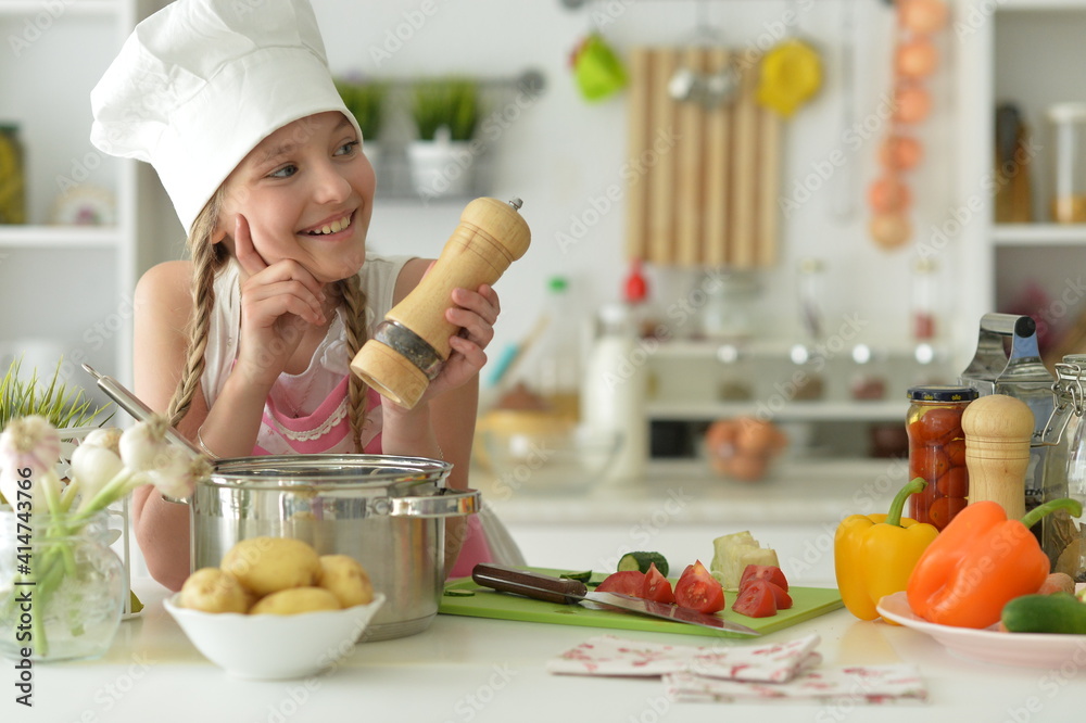 Cute happy girl coocking on kitchen Cute happy girl coocking on kitchen