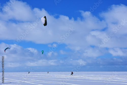 Kitesurfing in winter on ice. The Vistula Lagoon in Poland, a beautiful landscape.	
