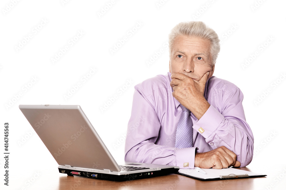 Old businessman working with laptop isolated on white background Old businessman working with laptop isolated on white background