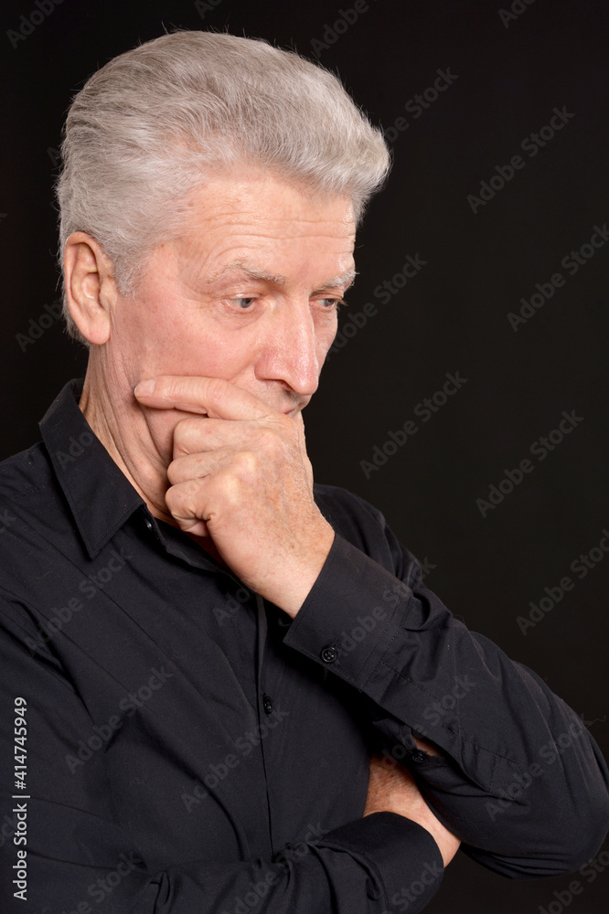 portrait of sad senior man  in studio