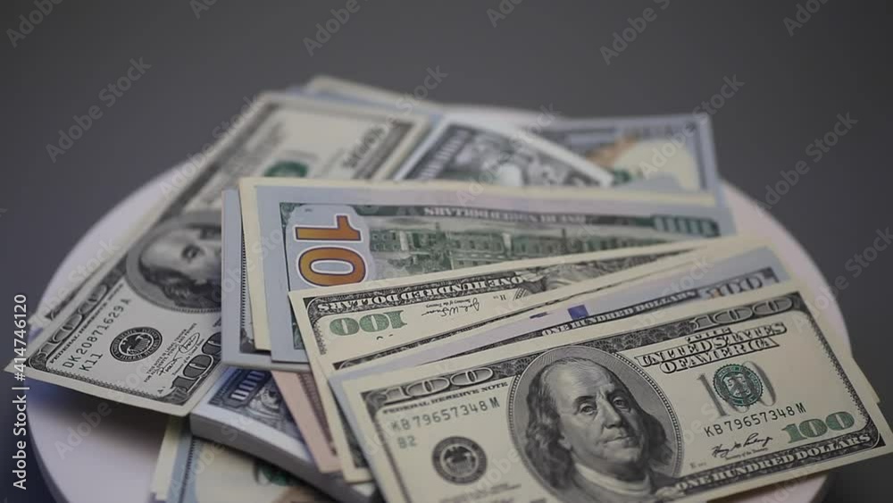 Hundred dollar bills and million dollar bills spinning on a table. Hundred dollar bills and million dollar bills spinning on a table.