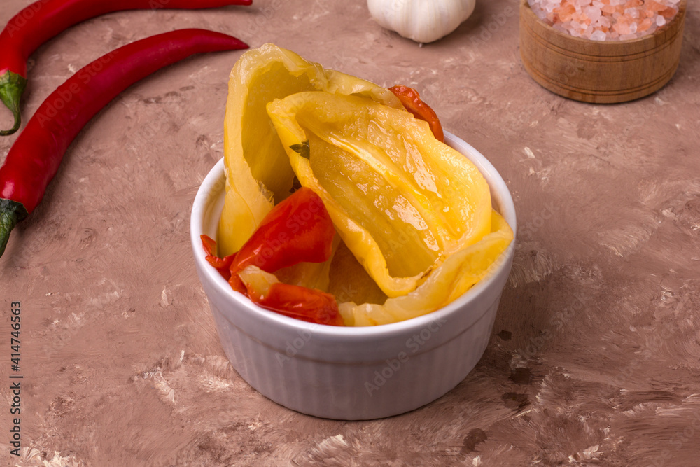 Fermented red and yellow bell peppers. Vegetarian food. Salted bell peppers. Pickled organic bell peppers. Homemade fermented foods. Food stocks.