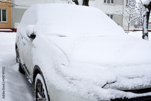 car covered with snow in the winter blizzard in the parking lot © Yekatseryna