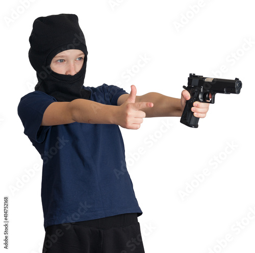 boy wearing balaclava or mask, taking aim with hand and pistol, imitating two barrels, on isolated background, symbol of child crime