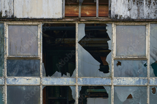 Abandoned industrial mill with broken windows photo